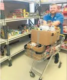  ?? Photo / Supplied ?? City Mission Whanganui’s Justin Mulligan with the food donated during The Village Snob’s Coffee for a Can campaign.