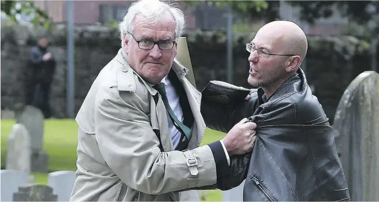  ?? BRIAN LAWLESS / THE CANADIAN PRESS ?? Canadian Ambassador to Ireland Kevin Vickers, left, wrestles with a protester at an event on May 26.