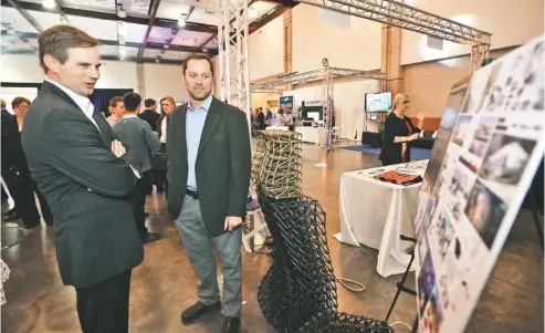  ?? STAFF PHOTO BY ANGELA LEWIS FOSTER ?? Platt Boyd, right, founder and CEO of Branch Technology, talks with Cam Doody during the Spirit of Innovation Awards luncheon and expo Wednesday at the Chattanoog­a Convention Center.