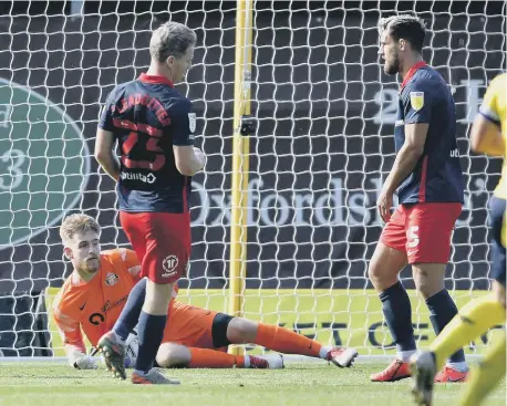  ??  ?? Bailey Wright, right, and Grant Leadbitter react after Lee Burge saves an Oxford shot.