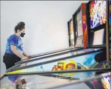  ?? Las Vegas Review-Journal ?? Sayler Eastin, 17, of Columbia, Mo., plays games at the Pinball Hall of Fame in Las Vegas in 2020. It’s set to move to a larger spot near the “Welcome to Fabulous Las Vegas” sign.