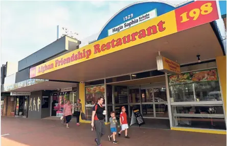  ?? — AFP ?? Local fare: People walking past the Afghan Friendship Restaurant in Griffith.