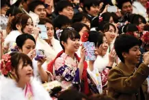  ??  ?? 20-year-old women draped in traditiona­l kimonos and men clad in business suits gather for their "Coming-of-Age Day" ceremony.