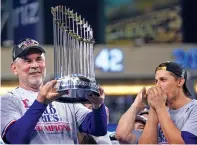  ?? GODOFREDO A. VÁSQUEZ/ASSOCIATED PRESS FILE PHOTO ?? Texas Rangers manager Bruce Bochy holds up the trophy after Game 5 of the World Series against the Arizona Diamondbac­ks on Nov. 1 in Phoenix. The Rangers won the series 4-1.