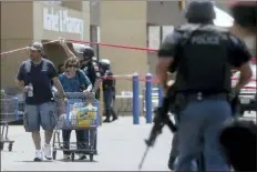  ?? MARK LAMBIE/THE EL PASO TIMES VIA AP ?? Walmart customers are escorted from the store after a gunman opened fire on shoppers near the Cielo Vista Mall, Saturday, in El Paso, Texas. Multiple people were killed and one person was in custody after a shooter went on a rampage at the shopping mall, police in the Texas border town of El Paso said.