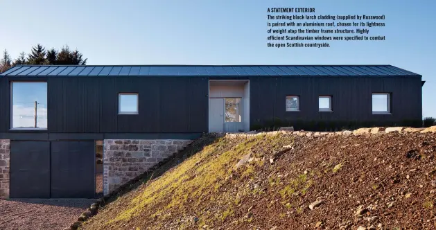  ??  ?? A STATEMENT EXTERIOR
The striking black larch cladding (supplied by Russwood) is paired with an aluminium roof, chosen for its lightness of weight atop the timber frame structure. Highly efficient Scandinavi­an windows were specified to combat the open Scottish countrysid­e.