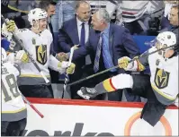  ?? THE CANADIAN PRESS/TREVOR HAGAN ?? The Vegas Golden Knights bench erupts after defeating the Winnipeg Jets in Game 5 of the NHL’s Western Conference Final in Winnipeg on Sunday. Golden Knights assistant coach Mike Kelly of Cornwall, third right, shakes hands with assistant coach Ryan...