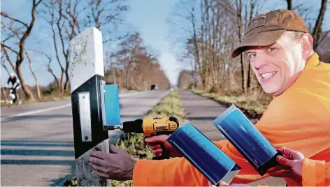  ?? RP-FOTO: OLAF STASCHIK ?? Markus Jäschke schraubt einen blauen Wildwarner an einen Leitpfoste­n an der Elberfelde­r Straße. Der Hegering Hilden hat rund 50 dieser Elemente gekauft und bei Straßen.NRW die Genehmigun­g eingeholt, die Reflektore­n an die Pfosten zu schrauben.