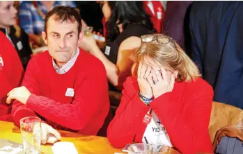  ?? JEFF MCINTOSH/THE CANADIAN PRESS ?? Members of Calgary’s “Yes” campaign react Tuesday to the results of a plebiscite on whether the city should proceed with a bid for the 2026 Winter Olympics. The plebiscite resulted in a 56-per-cent “No” against the bid.