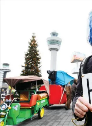  ?? PIROSCHKA VAN DE WOUW / REUTERS ?? A protester makes a point at a Greenpeace climate demonstrat­ion at Amsterdam Airport Schiphol in the Netherland­s on Dec 14.