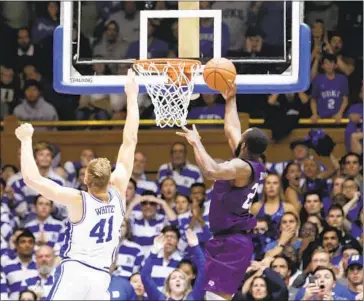  ?? Gerry Broome Associated Press ?? NATHAN BAIN of Stephen F. Austin made a buzzer- beating layup in overtime to defeat Jack White and Duke last year. The fame he gained helped his family rebuild a home, a school and a church in his native Bahamas.