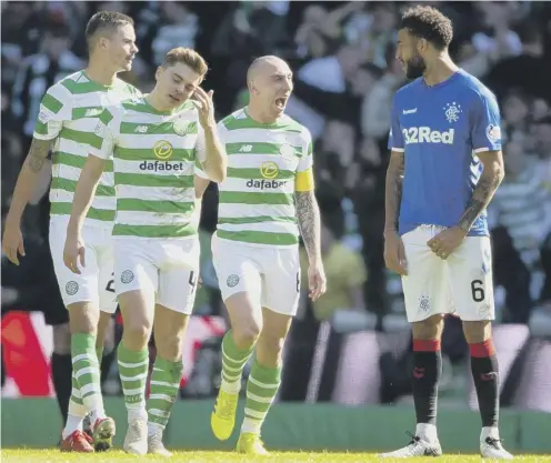  ??  ?? 0 Scott
Brown exchanges words with Connor Goldson after Celtic opened the scoring in the last Old Firm derby in March.