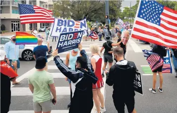  ?? MIKESTOCKE­R/SOUTHFLORI­DASUNSENTI­NEL ?? People celebrate and dance in the street onWilton Drive inWilton Manors afterJoe Bidenwas announced thewinnero­f the 2020 presidenti­al race Saturday.