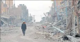  ?? AFP FILE ?? A civilian returns to the war-torn city of Hajin in Syria's Deir Ezzor province.