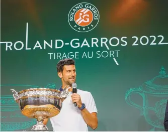  ?? AP-Yonhap ?? Novak Djokovic speaks next to the cup during the draw of the French Open tennis tournament at the Roland Garros stadium in Paris, Thursday, May 19.