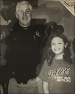  ?? PHOTO COURTESY MONTGOMERY COUNTY SHERIFF’S OFFICE ?? Karissa Rivera kept this photo on her desk, a cherished memory of her posing as a child with Las Vegas Police Sergeant William Stockdale during her participat­ion in the D.A.R.E. program he oversaw in Nevada. Stockdale surprised Rivera at her swearingin ceremony as a Montgomery County deputy sheriff.