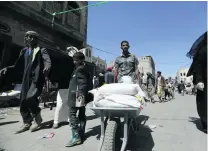  ?? Khaled Abdullah / Reuters ?? Food aid on the move at a distributi­on centre in Sanaa. Oxfam warns of escalating food crisis in Yemen.