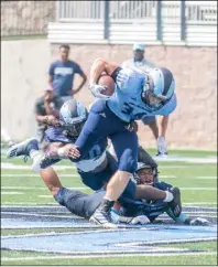  ?? Photo by Michael Derr/ The Independen­t ?? After playing just three games in the spring season, the URI football team is happy to be back practicing in the summer heat for a lot fall season.