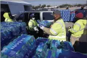  ?? DAVID J. PHILLIP — THE ASSOCIATED PRESS ?? Water is loaded into a vehicle at a city of Houston water distributi­on site on Friday. The drive-thru stadium location was set up to provide bottled water to individual­s who need it.