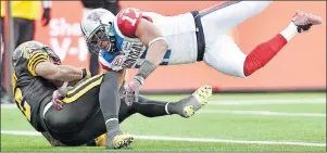 ?? CP PHOTO ?? In this file photo, Hamilton Tiger-Cats Nic Grigsby falls into the end zone for a touchdown past Montreal Alouettes cornerback Billy Parker during first half action in the CFL Eastern Division final in Hamilton, Ont., on Sunday, Nov. 23, 2014.