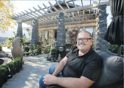  ?? PHOTOS: GORD WALDNER ?? Neil Robinson at Garden Architectu­re, where the outdoor oasis adds curb appeal and is a draw for visitors.