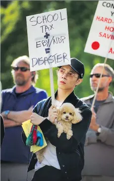  ?? ARLEN REDEKOP ?? Protesters rally against the NDP’s school tax surcharge before a town-hall meeting at the Hellenic Centre in Vancouver on Monday.