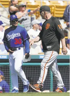  ?? Tim Warner / Getty Images ?? Managers Dave Roberts (left) of the Dodgers and Bruce Bochy of the Giants have promising prospects to spice the teams’ rivalry.