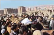  ??  ?? Men carry the coffin of a relative who died in one of Tuesday’s two bombings in Kabul, Afghanista­n