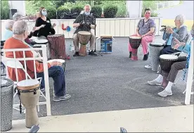  ?? COURTESY OF THE HERITAGE OF GREEN HILLS ?? Mark Seaman, center, of Earth Rhythms plays his drum.