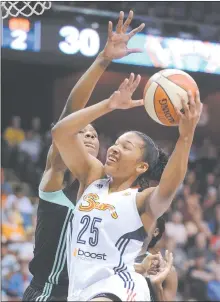  ?? FRED BECKHAM/AP PHOTO ?? Alyssa Thomas of the Sun (25) drives past Avery Warley of the Liberty in the first half of Sunday’s game at Mohegan Sun Arena.