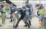  ?? [KIN CHEUNG/ THE ASSOCIATED PRESS] ?? Policemen in riot gear arrest a protester during a demonstrat­ion Tuesday at the airport in Hong Kong.