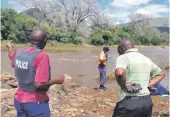  ?? PHOTOS: SUPPLIED ?? Police on the scene where the body of a spiritual leader was found after he allegedly downed in the Olifants River on the weekend. Right: Provincial Police Commission­er Nneke Ledwaba interacts with community members.