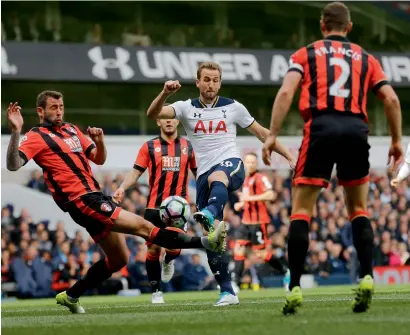  ?? AP ?? Tottenham Hotspur’s Harry Kane (centre), has a shot at the goal against Bournemout­h during the Premier League match at White Hart Lane stadium in London. —