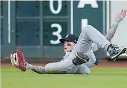  ?? AP ?? Alex Verdugo makes sliding catch for final out Sunday.