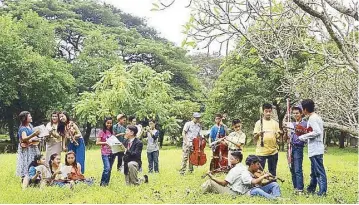  ??  ?? Cruz with some of the young musicians of Ang Misyon (above). Members of the OFY in Malaysia (below).