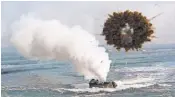  ?? AHN YOUNG- JOON, AP ?? A South Korean marine LVT- 7 landing craft sails through a smoke screen in March 2014 during United StatesSout­h Korea joint landing exercises in Pohang, South Korea.