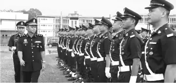  ??  ?? ACP Zailanni Amit inspects the parade at the event.