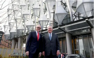  ?? — AFP ?? US secretary of state Rex Tillerson ( right) and US ambassador to Britain Woody Johnson stand outside the new US embassy in London on Monday. Mr Tillerson visited the new US embassy, a discreet move after criticism of US President Donald Trump, who...