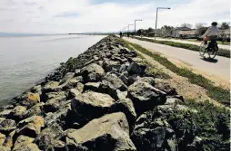  ?? Michael Macor / The Chronicle 2009 ?? The San Francisco Bay waters reach the breakwater levee that protects homes in Foster City, which was built on landfill, in March 2009.