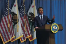  ?? RICH PEDRONCELL­I — THE ASSOCIATED PRESS FILE ?? Gov. Gavin Newsom speaks about his 2021-2022 state budget proposal during a news conference in Sacramento California is billions of dollars ahead of its tax collection­s projection­s despite many people being out of work because of the pandemic. California lost 1.6 million jobs in 2020 and nearly half a million people stopped looking for work.