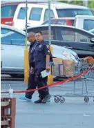  ?? JOHN LOCHER / AP ?? Police officers work Sunday near the scene of where Saturday’s mass shooting took place in El Paso, Texas.