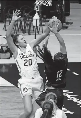  ?? DAVID BUTLER/POOL PHOTO/AP PHOTO ?? UConn forward Olivia Nelson-Ododa (20) defends against South Carolina guard Brea Beal (12) in the first half of Monday’s game in Storrs.
