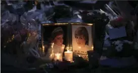  ?? KAMIL ZIHNIOGLU, THE ASSOCIATED PRESS ?? Photograph­s and flowers are placed in memory to late Princess Diana above the Pont de l’Alma tunnel in Paris on Thursday, the 20th anniversar­y of her death.