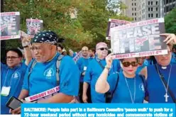  ?? —AFP ?? BALTIMORE: People take part in a Baltimore Ceasefire ‘peace walk’ to push for a 72-hour weekend period without any homicides and commemorat­e victims of gun violence in Baltimore, Maryland.