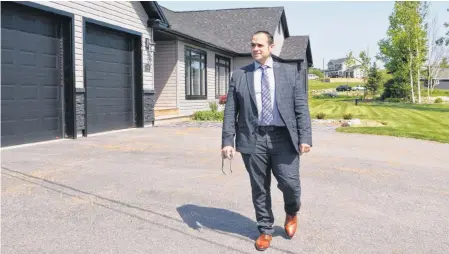  ?? SHARON MONTGOMERY-DUPE/CAPE BRETON POST ?? Joe Mcdonald, co-owner of Coldwell Banker Boardwalk Realty in Sydney, walks across the property of one of the houses now up for sale on the exclusive Prospect Drive subdivisio­n Kameron Collieries built in Coxheath in 2018 for mine managers who relocated from the United States. Mcdonald said the mining company is keeping one of the houses and six vacant lots, just in case coal prices change and they decide to reopen the mine.