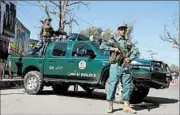  ?? GHULAMULLA­H HABIBI/EPA ?? Afghan forces stand guard outside a compound where an Afghan soldier killed a U.S. soldier and wounded others.