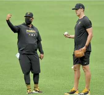  ?? Matt Freed/Post-Gazette ?? Pitching coach Oscar Marin works with Jameson Taillon during summer camp at PNC Park last season. Marin, entering his second season with the Pirates, will be critical to the developmen­t of the prospects the team received in the Josh Bell trade.