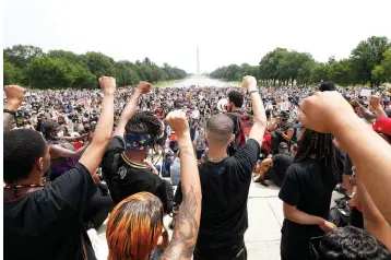  ?? Alex Brandon/Associated Press ?? Demonstrat­ors protest Saturday at the Lincoln Memorial in Washington over the death of George Floyd, a black man who was in police custody in Minneapoli­s. Floyd died after being restrained by Minneapoli­s police officers.