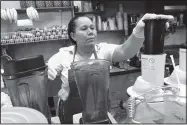  ?? TINA FINEBERG/THE ASSOCIATED PRESS ?? Celina Alvarez, 51, works at Jugueria de regreso al Eden, her shop in the Queens borough of New York, on Aug. 3.