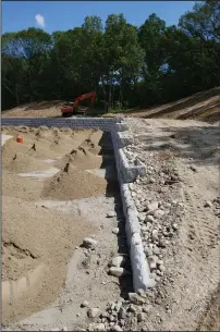  ?? Joseph B. Nadeau photos ?? Crews continued work on the future home of the Woonsocket High School softball team, Tuesday, putting the finishing touches on a retaining wall.